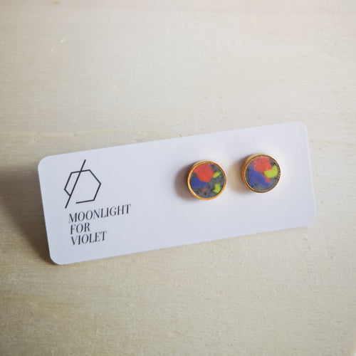 Moonlight for Violet colourful clay circle studs. bright orange, lavender purple and wasabi  green. clay smudges on granite background.