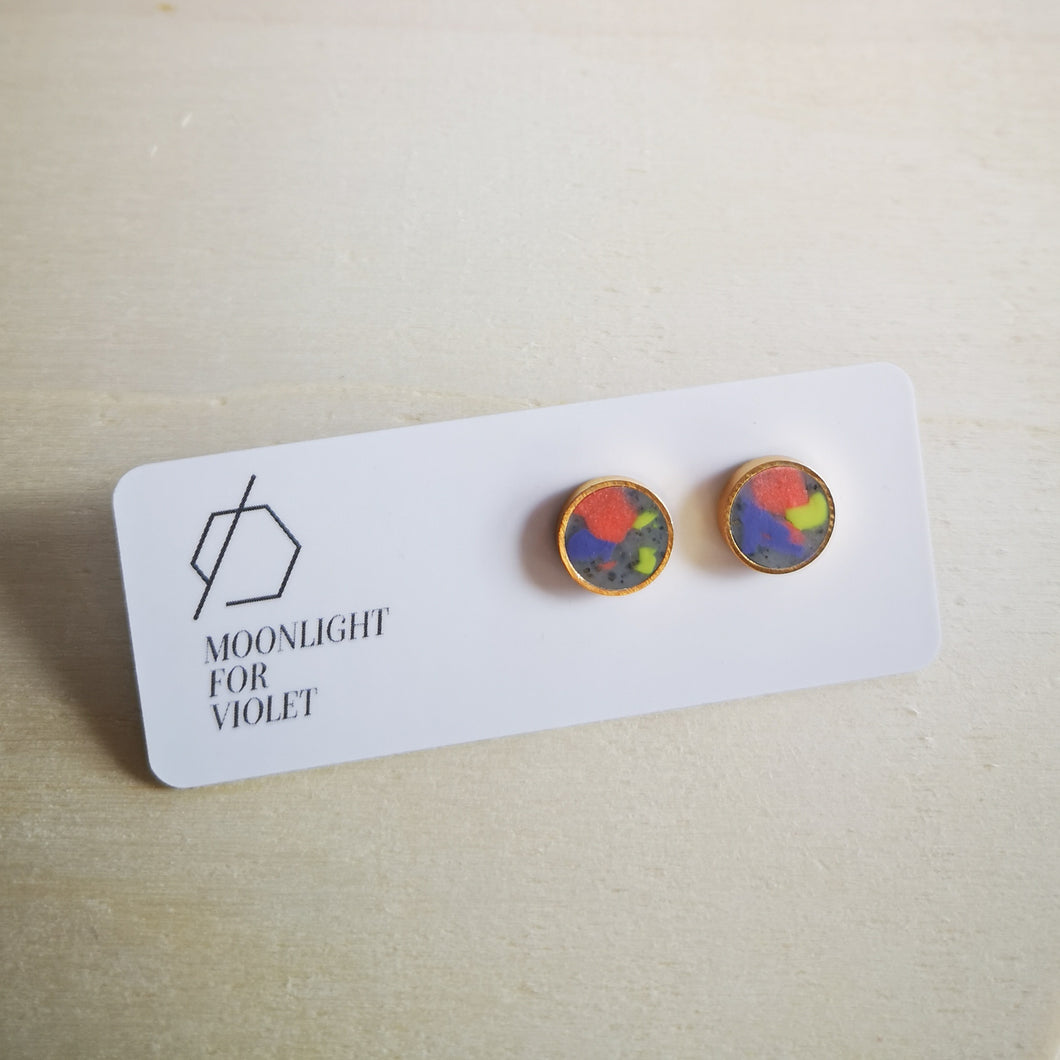 Moonlight for Violet colourful clay circle studs. bright orange, lavender purple and wasabi  green. clay smudges on granite background.